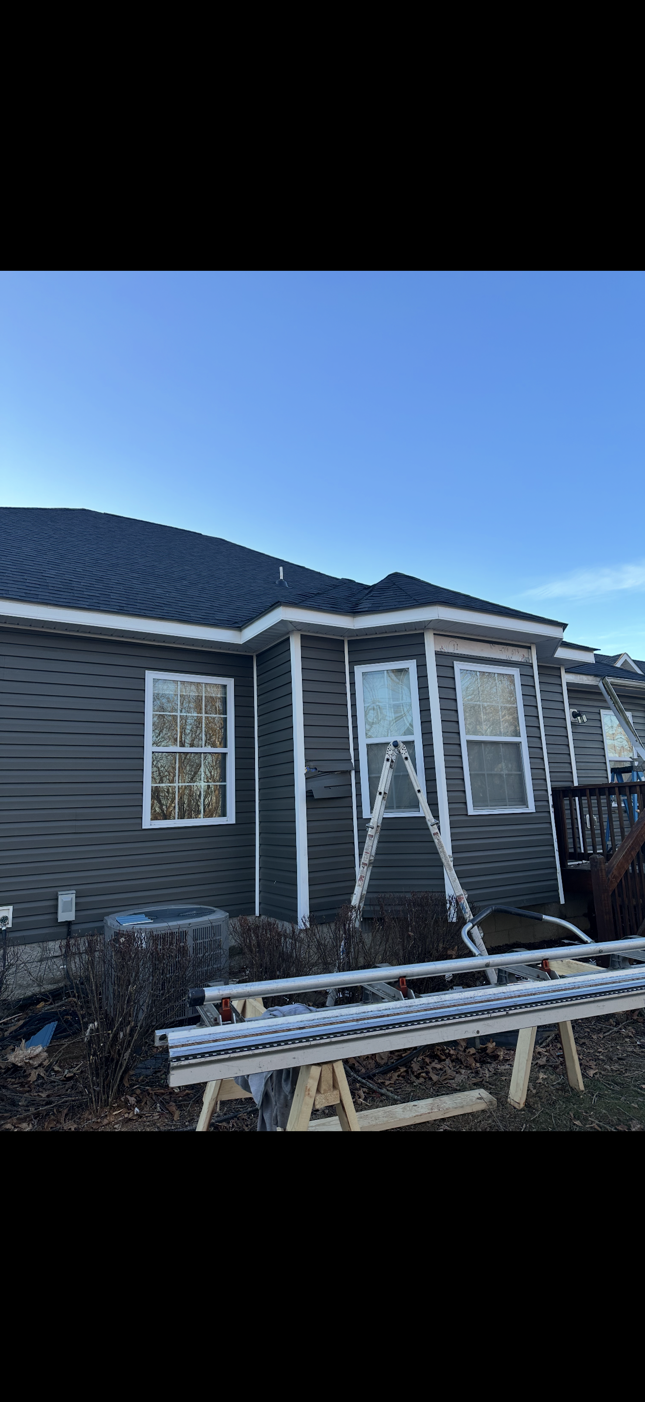 Completed roof and gutter installation on gray home